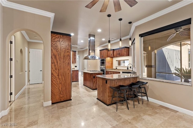 kitchen featuring sink, ceiling fan, dark stone countertops, kitchen peninsula, and island exhaust hood