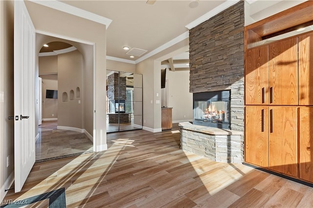 hallway with wood-type flooring and ornamental molding