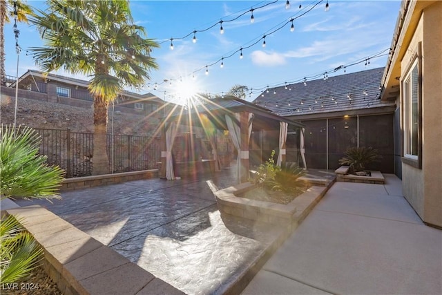 view of patio / terrace featuring a sunroom