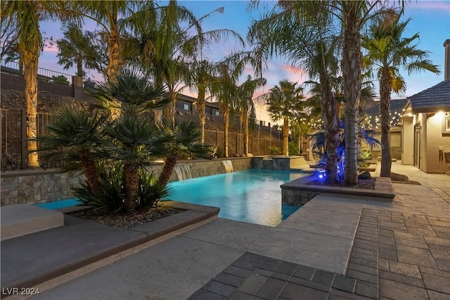 pool at dusk with pool water feature