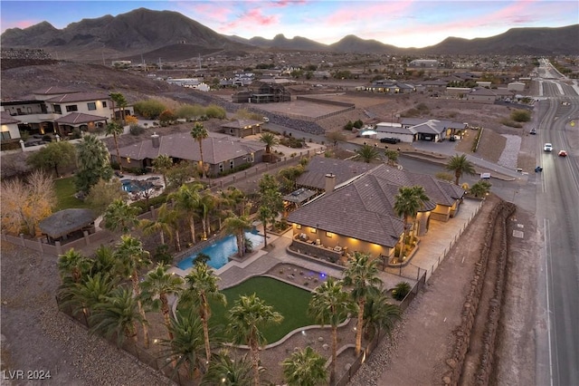 aerial view at dusk featuring a mountain view