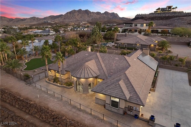 aerial view at dusk featuring a mountain view