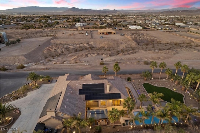 aerial view at dusk featuring a mountain view