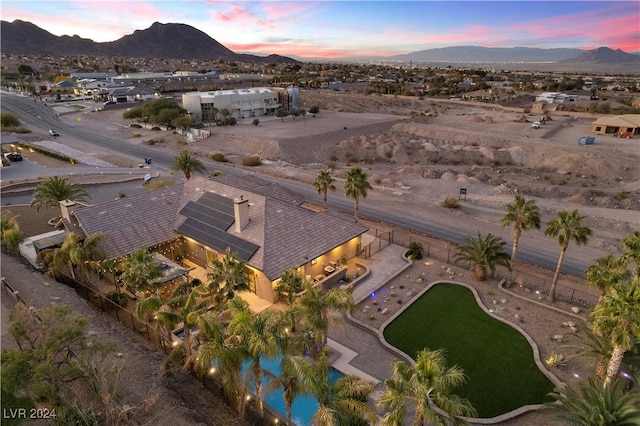 aerial view at dusk featuring a mountain view