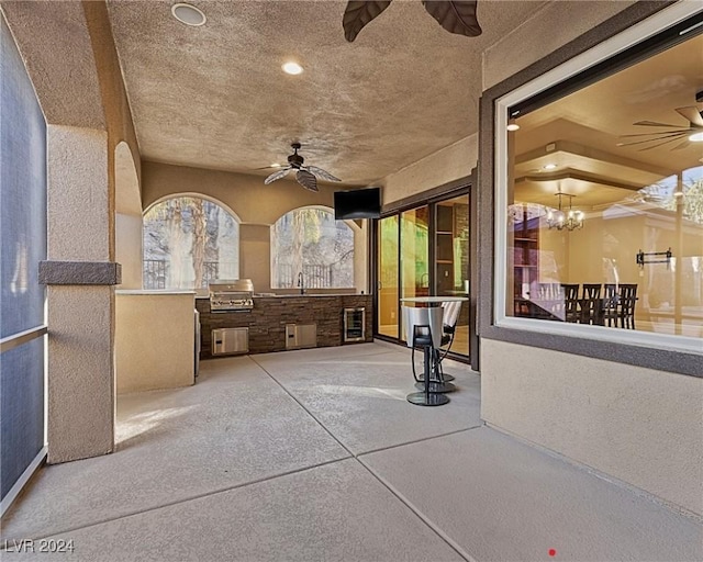 view of patio / terrace with an outdoor kitchen, area for grilling, and ceiling fan