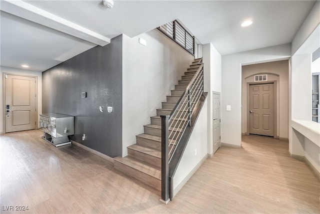 staircase featuring hardwood / wood-style floors