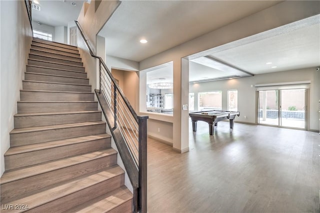 stairs featuring hardwood / wood-style floors and pool table