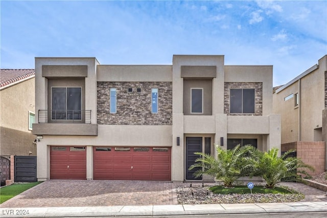 view of front facade with a balcony and a garage