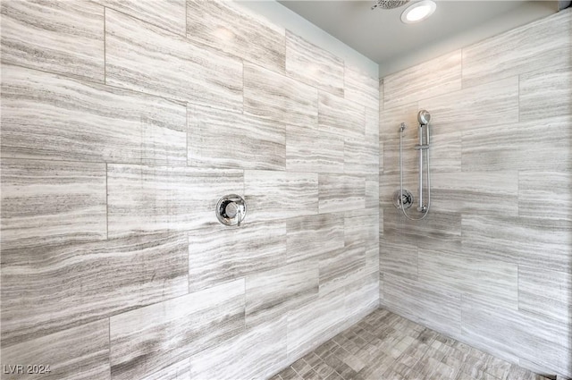 bathroom with a tile shower