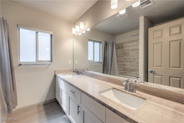 bathroom with vanity, hardwood / wood-style flooring, and curtained shower