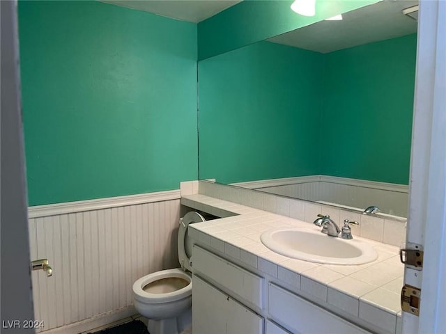 bathroom with vanity and toilet