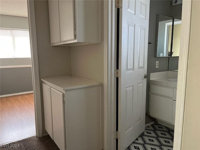 clothes washing area with light hardwood / wood-style flooring