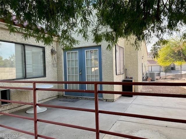 view of side of property with cooling unit and a patio area