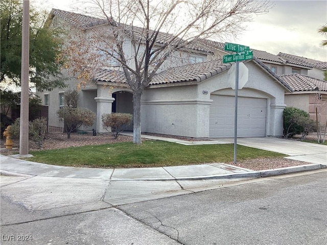 view of front facade with a front lawn and a garage