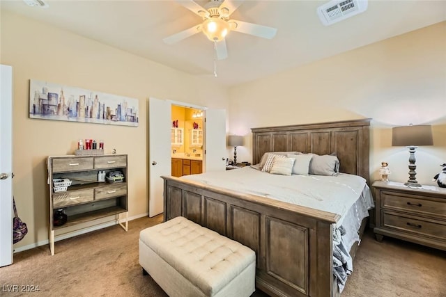 bedroom with connected bathroom, ceiling fan, and light carpet