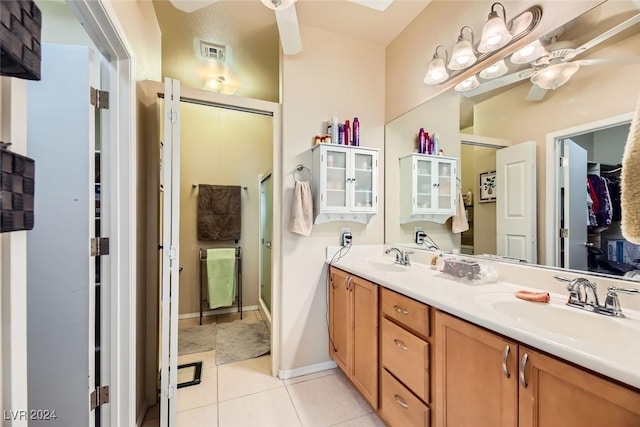 bathroom featuring vanity, tile patterned floors, a shower with door, and ceiling fan