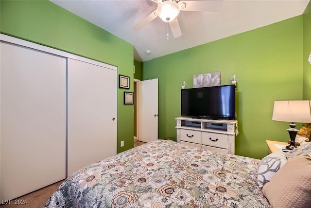 carpeted bedroom with ceiling fan and a closet