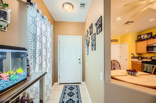 tiled foyer entrance with ceiling fan