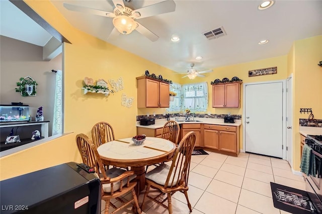 dining room with ceiling fan, sink, and light tile patterned flooring