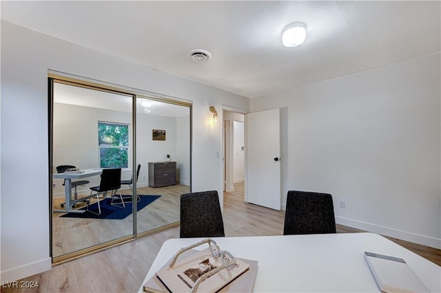 office with hardwood / wood-style flooring and a textured ceiling