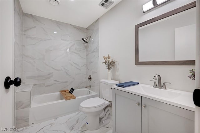 full bathroom with vanity, tiled shower / bath, and toilet