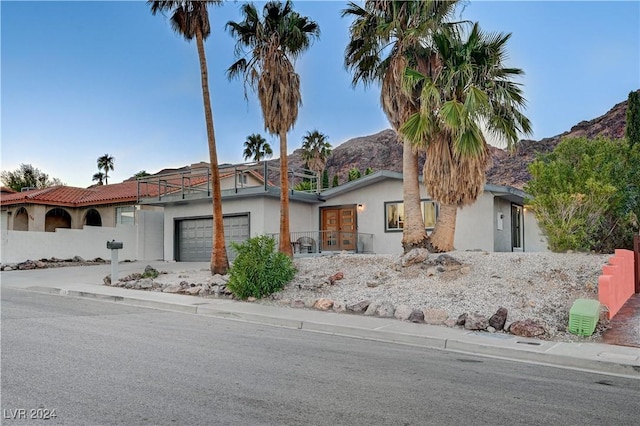 view of front facade featuring a mountain view and a garage