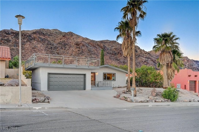 view of front of home with a mountain view and a garage