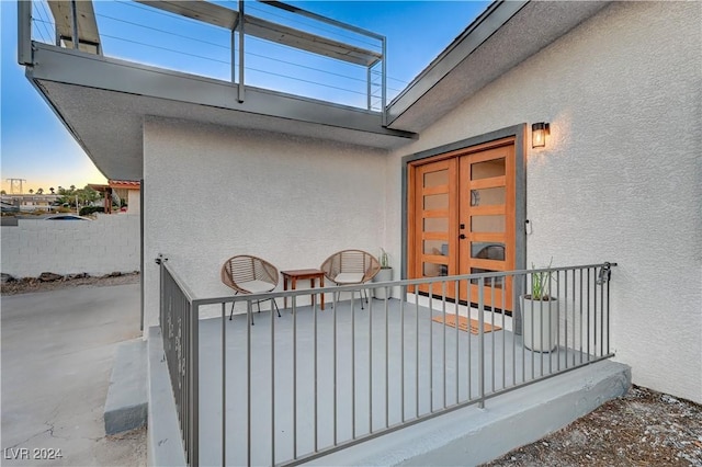 exterior entry at dusk featuring french doors