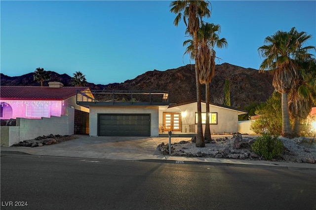 view of front of home with a mountain view and french doors