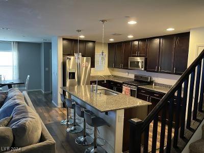 kitchen featuring a center island with sink, sink, dark hardwood / wood-style floors, appliances with stainless steel finishes, and decorative light fixtures