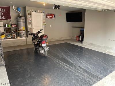 garage with a garage door opener and secured water heater