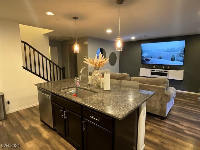 kitchen featuring decorative light fixtures, sink, dark stone countertops, a kitchen island with sink, and stainless steel dishwasher