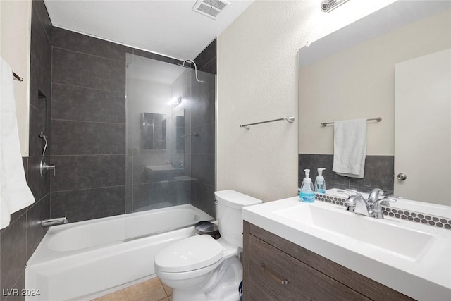 full bathroom with tile patterned floors, vanity, toilet, and tiled shower / bath