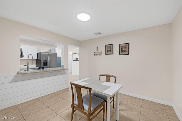 dining room featuring light tile patterned floors and sink