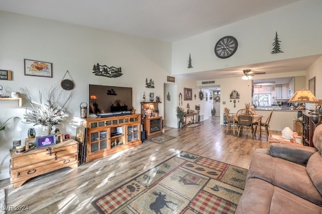 living room with hardwood / wood-style flooring and ceiling fan