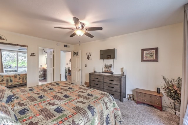 carpeted bedroom with ceiling fan, ensuite bathroom, and crown molding