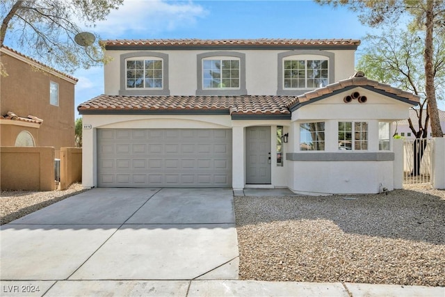 mediterranean / spanish home featuring a garage