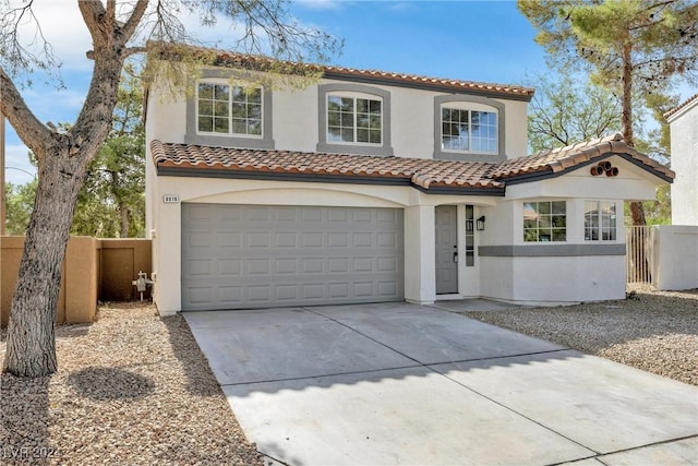 mediterranean / spanish home with a garage