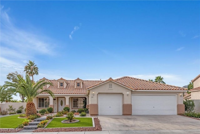 mediterranean / spanish home with a front lawn and a garage