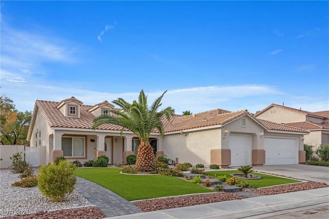 mediterranean / spanish-style home featuring a front lawn and a garage