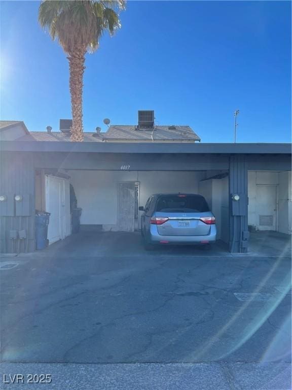 exterior space with a carport and central AC unit