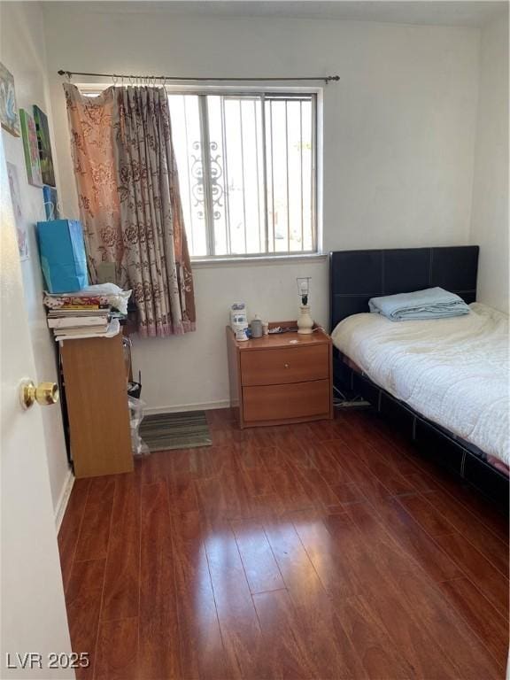 bedroom with dark hardwood / wood-style floors