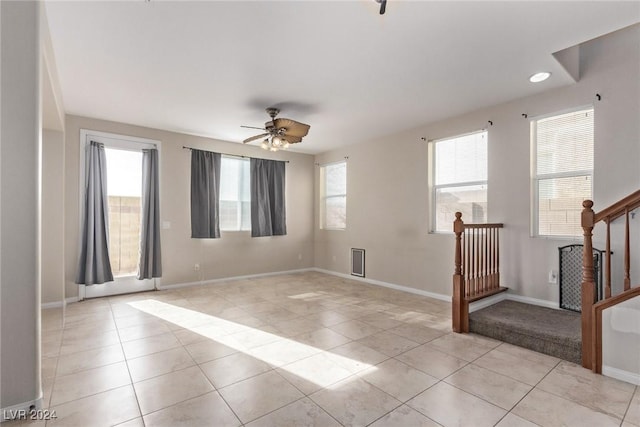 unfurnished room featuring light tile patterned floors, plenty of natural light, and ceiling fan