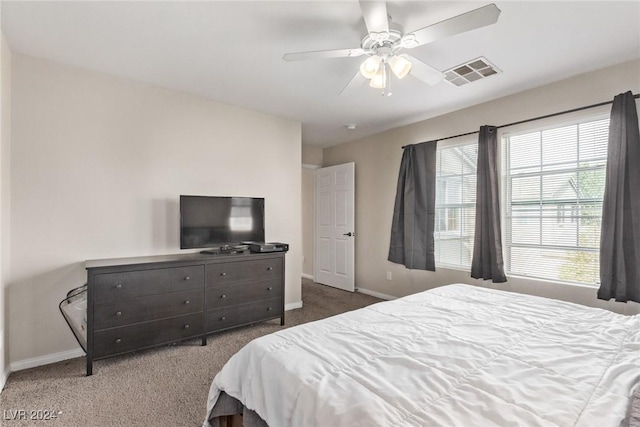 bedroom featuring dark colored carpet and ceiling fan