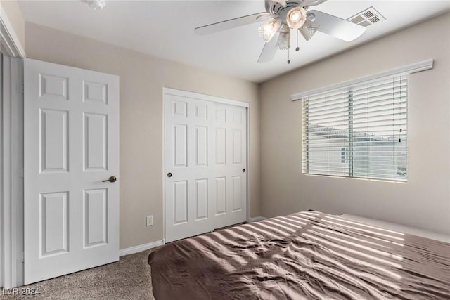 carpeted bedroom featuring a closet and ceiling fan