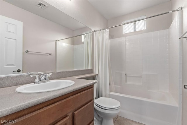 full bathroom featuring tile patterned flooring, vanity, shower / bath combo, and toilet