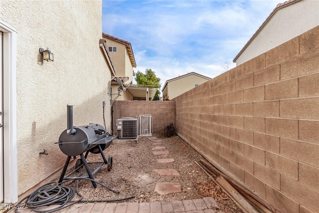 view of patio / terrace with central AC unit and a grill