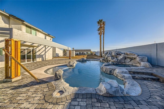 view of pool featuring an in ground hot tub and a patio