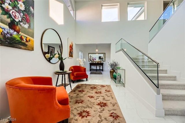 interior space with a multi sided fireplace and a high ceiling