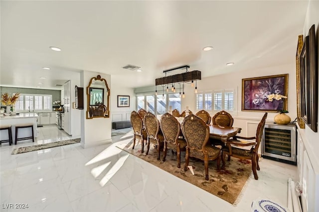 dining area with a healthy amount of sunlight and beverage cooler